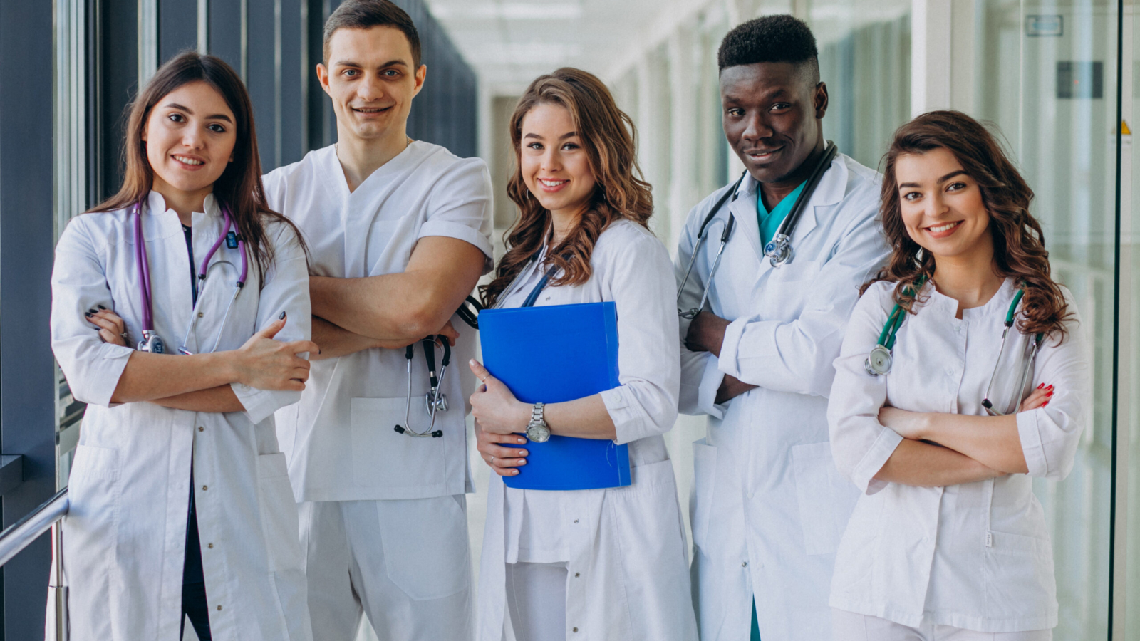 team-of-young-specialist-doctors-standing-in-the-corridor-of-the-hospital