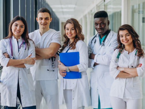 team-of-young-specialist-doctors-standing-in-the-corridor-of-the-hospital